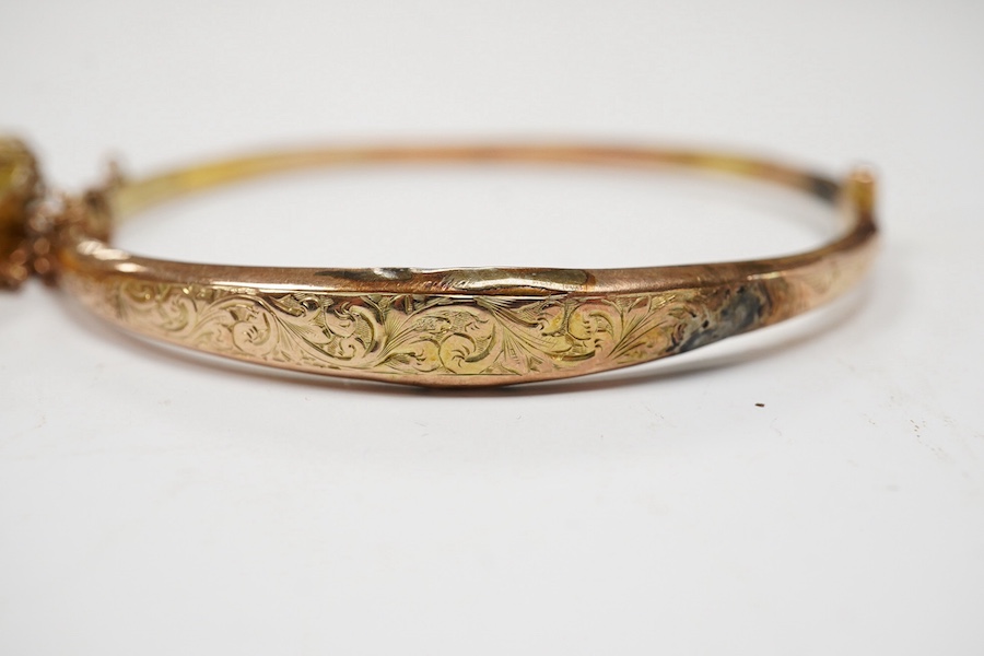 An Edwardian yellow metal, diamond and seed pearl set hinged bangle and one other late Victorian engraved 9ct gold hinged bangle, both a.f., gross weight 14.6 grams. Condition - poor